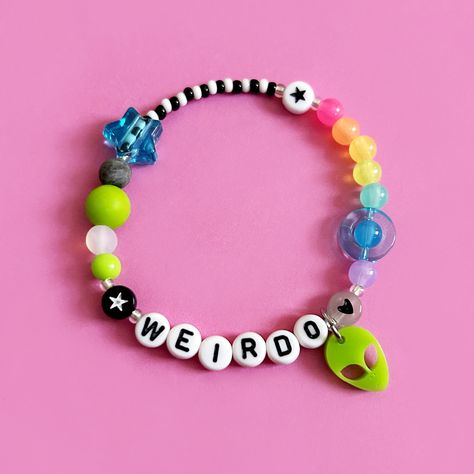 Personalise with any name or word. Rainbow space themed bracelet featuring the cutest laser cut acrylic alien charm on a stainless steel jump ring.  Silicone bead, planet bead and sliding star add an extra sensory tactile detail to this bracelet.  Choose from the size options at checkout. Bracelet Ideas With Words, Alien Bracelet, Plastic Bead Bracelets, Glass Beads Bracelet Ideas, Space Bracelets, Bead Bracelet Words Ideas, Kandi Bracelet Ideas, Cool Bracelet Ideas, Glass Bead Bracelet Ideas