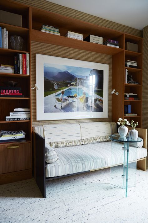 A Slim Aarons photograph backs a custom daybed upholstered in this study | archdigest.com Custom Daybed, Daybed Upholstered, Study Wallpaper, Downstairs Loo, White Interiors, Manhattan Apartment, American Interior, Slim Aarons, Interiors Dream