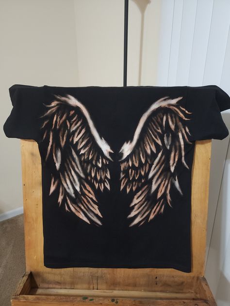 This one of a kind creation is a black t-shirt, hand painted with bleach.  **Please message before buying.** Make sure to leave details on which design you are interested in. I can do almost any theme, so if you are interested in this design or something similar please let me know. The normal time frame for you to receive the shirt is between 2 to 3 weeks.  Shirts will be washed and dried after bleaching, please let me know if you have any sensitivity to laundry detergent. Spine Shirt Design, Bleach Wings Shirt, Black T Shirt Bleach Design, Bleach Painting Tshirts, Black Bleached Shirt Diy, Custom Bleach Hoodie, Bleach Shirt Diy Ideas Stencils, Bleaching Black Shirts, Black Bleached Shirt Design