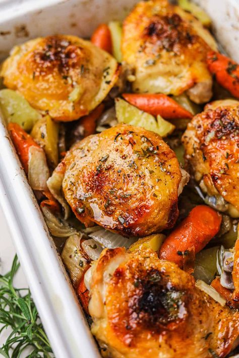 Roasted Chicken Thighs and Vegetables is an easy, hearty one-pan dinner recipe that results in crispy, juicy chicken and flavorful vegetables. Just toss the chicken, potatoes, onions, and carrots in mustard, honey, and olive oil, season, then roast in the oven until golden! Roasted Chicken Thighs And Vegetables, Roast Chicken Thigh Recipes, Oven Roasted Chicken Thighs, Oven Baked Chicken Thighs, Roasted Chicken And Potatoes, Potatoes Onions, Hearty Dinner Recipes, Roasted Chicken Thighs, Flavorful Vegetables