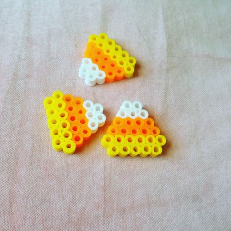 Candy corn perlerbead Perler Bead Candy Corn, Peeler Beads Patterns Halloween, Fall Melty Beads, Mini Perler Bead Patterns Halloween, Fall Perler Bead Patterns Small, Creepy Perler Bead Patterns, Perler Beads Candy, Halloween Perler Bead Patterns Small, Melted Beads Ideas