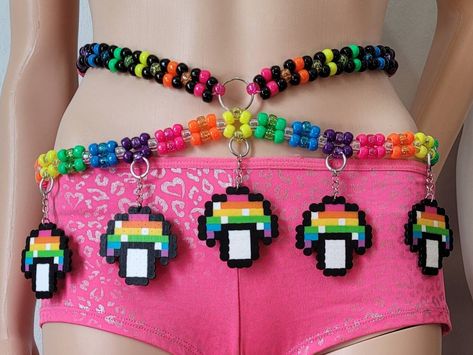 This kandi harness is made with neon pony beads and mushroom perlers. Glows under blacklight! Includes one kandi belt. Harness sold separately. One size fits most. This item ties in the back & around neck for easy adjusting. This Item is premade and is ready to ship! Perfect for any event! You will get lots of compliments in this unique wearable art! Stand out at your next event! Edm festival  Raves Party  Rave outfit  Festival outfit Pride Mardi gras Rave gift  Rave birthday Glow party Perler Belt Chain, Sullivan King Kandi, 3d Kandi Patterns, Kandi Lighter Holder, Rave Belt, Kandi Belt, Kandi Harness, Mushroom Kandi, Rave Kandi Bracelets