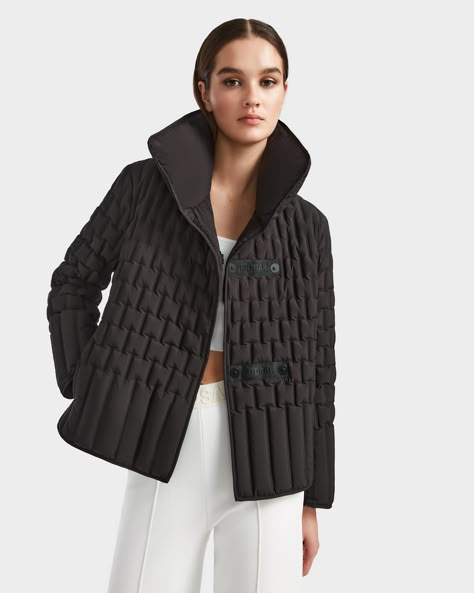 Make a statement in the RISA by RUDSAK, an elevated and elegant women's quilted jacket. With an exquisite quilted pattern, this light down jacket features a sophisticated puff collar, seamlessly complemented by the webbing center front button and snap closure system. The invisible side zipper pockets offer discreet functionality, while the Rudsak logo patch at the center back collar adds a distinctive touch. Crafted from Xtra Light fabric, RISA combines elevated elegance with lightweight comfort Quilted Dress, Light Down Jacket, Leather Varsity Jackets, Fall Outerwear, Black Quilted Jacket, Womens Quilted Jacket, Light Down, Quilted Pattern, Quilt Jacket