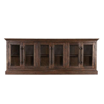 Each piece of the Tallahassee collection starts with a weathered finish over solid mango wood and features accents like thick multi-layered pedestals and triple-beveled waterfall-edged table tops, resulting in a traditional yet contemporary look. The fine details of this Tallahassee collection truly bring to life an elegance not easily found. | Millwood Pines Tallahassee 95" Wide Mango Solid Wood Sideboard Wood in Brown | 37 H x 95 W x 18 D in | Wayfair French Country Buffet, Traditional Sideboard, Solid Wood Sideboard, Black Sideboard, Kitchen Sideboard, Wood Sideboard, Brass Knobs, Solid Mango Wood, Home Trends