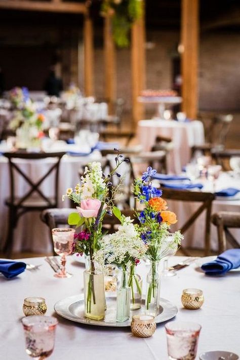 wildflower centerpiece for boho wedding / http://www.himisspuff.com/boho-rustic-wildflower-wedding-ideas/8/ Whimsical Wildflower Wedding, Wildflower Centerpieces, Round Wedding Tables, Wildflower Wedding Theme, Wedding Flowers Wildflowers, Wedding Table Decorations, Wildflower Wedding, Wedding Table Centerpieces, Table Flowers