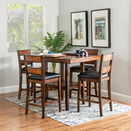 This five-piece counter set offers a stylish blend of modern and traditional design, making it a perfect addition to any home. The smooth, elegant veneer tabletop exudes sophistication, while the convenient lower shelf provides additional storage, making it both functional and aesthetically pleasing. Complementing the tabletop are four counter stools featuring a sleek ladderback design, which adds a touch of classic charm. The seats are upholstered in easy-to-clean black faux leather, ensuring t Tiny Dining Rooms, Eating Table, Kitchen Table Wood, Ladder Back Chairs, Counter Height Chairs, Tall Table, Counter Table, Counter Height Table, Leather Seats