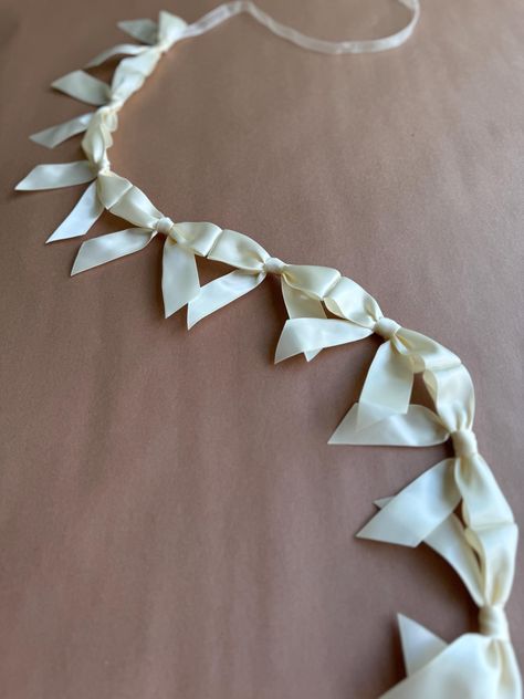 This dainty bow garland is perfect for decoration for any occasion. Use it for bridal parties, bachelorette weekends, baby showers, teen birthday parties, or even to decorate a little girl's room. Each bow is 3.5" wide and is tied off with ribbon on each end for convenient hanging.  Please select your desired length and color when ordering. Further customization available upon request! Just send me a message when ordering and we'll create something beautiful. Returns may be limited for customize Last Chapter Bachelorette, Bows Bachelorette Party, Bow Themed Party Decor, Black And White Bridal Shower Decor, Engagement Party Decorations At Home, Pearl Party Decor, Pearl Themed Bridal Shower Decor, Beige Bachelorette Party, Bow Wedding Decor