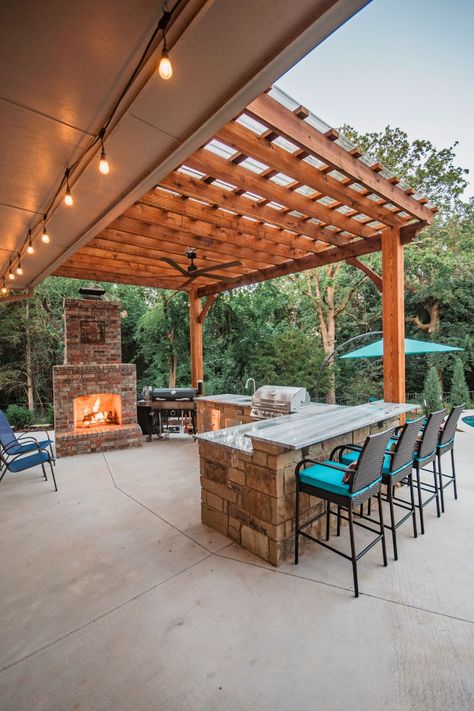 A custom outdoor kitchen, pergola, and fireplace turn this space into the ultimate fall hangout spot! Outdoor Fireplace With Kitchen, Pergola And Fireplace, Pergola With Fireplace, Fall Hangout, Outdoor Kitchen Pergola, Kitchen Pergola, Custom Outdoor Kitchen, Covered Outdoor Kitchens, Hangout Spot