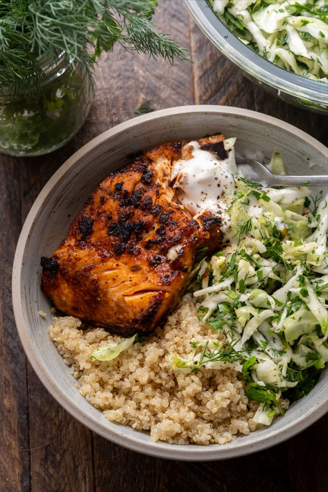 These Honey Harissa Salmon Bowls are loaded with fluffy quinoa, smoky broiled salmon and served with a fresh herby cabbage slaw and a dollop of yogurt. Hearty, healthy and ready in under 30 minutes. Healthy Easy Bowl Recipes, Mediterranean Salmon Quinoa Bowl, Salmon And Beans, Salmon And Chickpeas, Salmon Healthy Meals, High Protein Salmon Bowl, Bbq Salmon Bowl, Wandering Chickpea, Salmon Quinoa Bowl