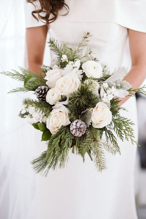 Elegant Winter Wedding Bouquet | A beautiful winter wedding bouquet featuring white roses, pine greenery, and frosted pinecones. See more winter wedding flowers, winter wedding florals, elegant wedding bouquet. Book Nina for your Colorado wedding or elopement at larsenphoto.co! Evergreen Bouquet Wedding, Pinecone Wedding Bouquet, Winter Wedding Bouquet Evergreen, Winter Wedding Bouquet Blue, All White Winter Wedding, Christmas Wedding Bouquet, Wedding Flowers Winter, Flowers Winter Wedding, Winter Wedding Florals