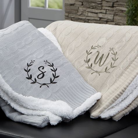 "Our Floral Wreath Personalized Throw Blanket has an incredibly, soft knitted sweater pattern on the front and an added bonus of sherpa on the reverse side. Medium weight that's not too heavy or too light makes it a cozy addition to your couch or sofa on a chilly evening.  - Embroidered with any name and choice of thread color - Cable knit front and sherpa on the reverse side - Measures 50\" W x 60\" L - Available in grey or tan - Face: 100% acrylic - Reverse: 100% polyester - Machine wash cold Monogram Throw Blanket, Knitted Sweater Pattern, Monogram Blanket, Cable Knit Throw Blanket, Grey Throw Blanket, Personalized Throw Blanket, Custom Throw Blankets, Floral Wreath Design, Cable Knit Throw