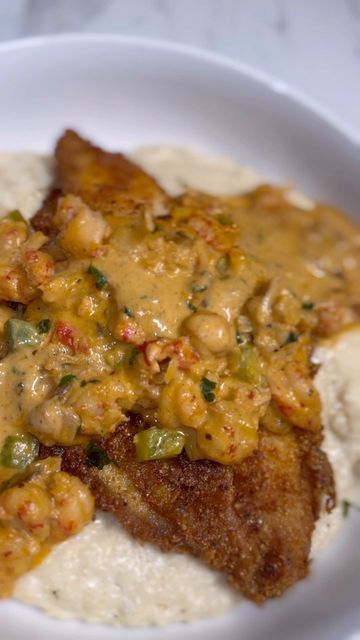 Chef Cordarrius Green on Instagram: "Y’all had Sundee dinner yet or y’all still in church? 👀 Catfish & Grits GRAB THE COOKBOOKS ON AMAZON THRU THE LINK IN BIO FULL STEP BY STEP RECIPE IS ON YOUTUBE (link in bio) Ingredients 4 catfish fillets 1/2 lb frozen, cooked crawfish tails 1 cup grits 1 cup yellow cornmeal 1 cup all purpose flour 2-3 cups heavy cream 2-3 cups chicken broth 1 stick unsalted butter 1/2 cup diced bell peppers 1/2 cup diced red onion Mustard (for binding) Hot sauc Fried Catfish With Cream Sauce, Catfish And Grits Soul Food, Fried Catfish And Grits, Catfish Acadiana Recipe, Recipes With Crawfish Tails, Catfish Atchafalaya Recipe, Stuffed Catfish Recipes, Smothered Catfish, Catfish And Grits