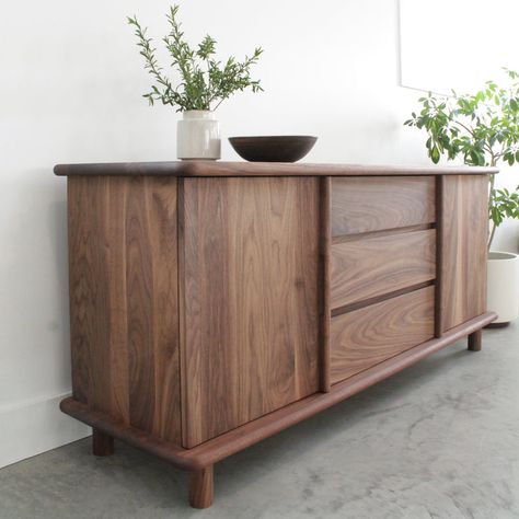 When you need a decorative storage solution in an area with limited space, the Eastvold Furniture Classic Credenza Small is ideal. It carefully hides the items you place behind the two solid wood doors. The interior space of the Classic Credenza Small features adjustable shelving and wire management portals for all of your media needs. The credenza can also accommodate wiring for media equipment if you choose to use it as a TV stand or media center. The furniture itself does not require a large Credenza Decor, Home Office Shelves, Wood Credenza, Soft Edges, Swinging Doors, Outdoor Table Lamps, Media Storage, Modern Cabinets, Glass Shelves