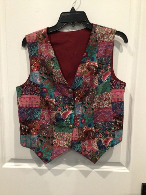 New without tags women’s vest estimate size large see dimensions  Sleeveless v neck button down fully lined Patchwork quilt design Measurements 15 inches across shoulders  19 inches armpit to armpit  21 inches shoulder to hem  Bin Nina Vintage Vest Outfit, Thrift Inspiration, Diy Vest, Patterned Vest, Patchwork Vest, Clothing Board, Colorful Vest, Vest Blouse, Sweater Vests