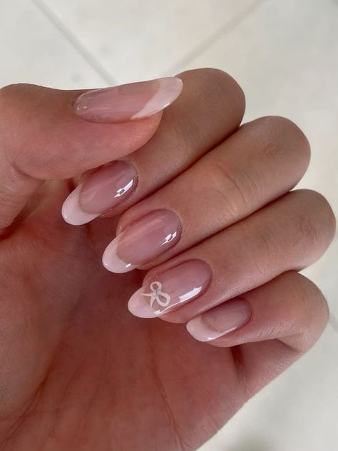 coquette nails: pale pink French tips with a ribbon accent Nails Acrylic Girly, Pink Bow Acrylic Nails, Almond French Tip Nails With Bow, Simple And Classy Nails, Bow Pink Nails, Pink French Tip Nails With Bow, French Tip Nails Bow, Baby Pink Nails With Bow, Bow Nails Almond