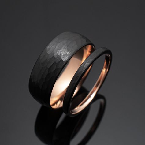 Your wedding ring set order includes + One 8mm Black Hammered Obsidian-styled tungsten Wedding Band with Rose Gold inlay + One 2mm Black Hammered Obsidian-styled tungsten Wedding Ring with Rose Gold inlay + Both Come inside Wax Sealed Ring Boxes. Limited Time: Free Matching Set of Black Silicone Bands w/ Order. *Durable - Incredibly Scratch-Resistant to always look great. *Comfort-fit & Weighty - Designed to fit well and feel good in your hand. *Made to order - Every ring we ship is unique and o Matching Bands His And Hers, Black And Rose Gold Wedding Rings, Black And Rose Gold Ring, Black Wedding Bands His And Hers, Gold And Black Wedding Ring, Rings Engagement For Men, Wedding Ring Black Women, Obsidian Wedding Band, Wedding Band And Engagement Ring Set