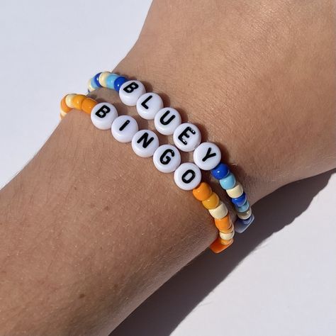 Bracelets inspired by the show Bluey! 💙🧡 Care Bear Bracelet, Word To Put On Bracelet, Friends Bracelets Tv Show, Disney Braclets Ideas, Bracelet Making Ideas Clay Beads, Sayings To Put On Bracelets, Bestie Bracelet Ideas, Bluey Bracelet Ideas, Bead Friendship Bracelet Ideas