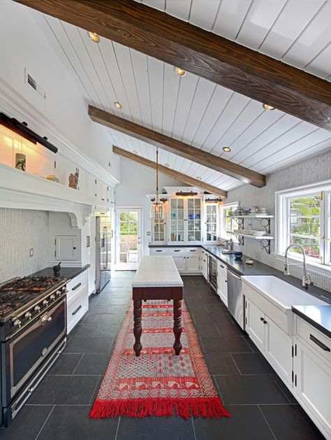 Galley kitchen. The exposed beams and paneled ceiling add character. A great choice to use dark gray slate floor tiles. Stove Alcove, Cornue Range, Diy Pool Table, Slate Countertop, Range Design, Old Victorian House, Skillion Roof, Old Victorian Homes, Black Floor Tiles