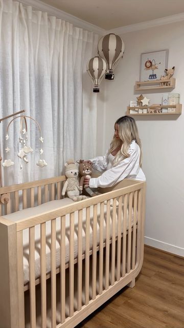 Ani Goulayan on Instagram: "Decorate my nursery with me 🩵 Tags for everything below: I’ll also post direct links in stories 🫶🏼 Furniture: RH baby and child Shelves, wooden toys and books on my Amazon storefront Rug: @westelm Hot air balloon & paintings: @etsy Giraffe: @potterybarnkids Drawers and organizers: @ikea Knitted animals: @cuddleandkind Stars and moon mobile: @etsy Glider chair: @worldmarket Now we’re finally ready for baby to come 🫶🏼" Ballon Nursery Decor, Nursery Ideas Giraffe, Nursery Ideas Hot Air Balloon, Gold Baby Nursery, Hot Air Balloon Nursery Decor, Nursery Aesthetic, Nursery Idea, Moon Mobile, Hot Air Balloon Nursery