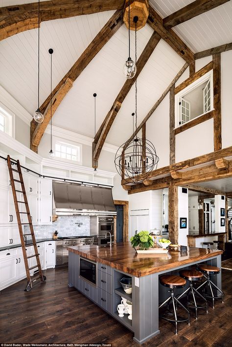 Stunning: This American property was singled out for its large kitchen island work space and quirky ladders used to reach extra storage. This Midwest Lake House renovation was completed in 2015 and cost more than $2,000,000 (£1.58million). The owner has a lifelong passion for rowing and tasked the architects with designing a lake residence that would be reflective of classic American boathouse style Interior Design Per La Casa, Large Kitchen Island, Cottage Kitchens, Hus Inspiration, Interior Design Magazine, Farmhouse Style House, Large Kitchen, The Ceiling, Style At Home