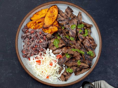 This grilled skirt steak—a beloved staple at Nicaraguan fritangas—is infused with the bittersweet flavor of Seville oranges. Find the recipe here. Nicaraguan Recipes, Nicaraguan Food, Carne Asada Recipes, Grilled Skirt Steak, Herb Salad, Ribs On Grill, Grilled Beef, Juicy Steak, Steak Recipe