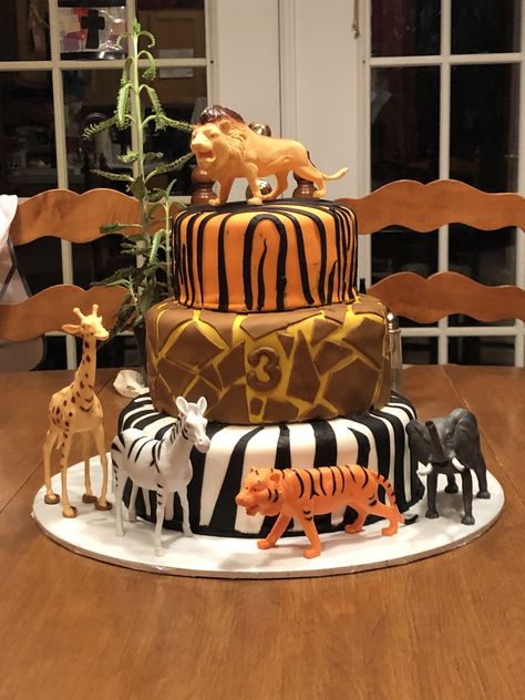 Three tired cake in animal prints for 3 year old birthday party. Born Two Be Wild Cake Ideas, Animal Print Cakes Birthday, Three Year Old Zoo Party, 3 Tier Safari Themed Cake, Jungle Theme 2 Tier Cake, Jungle Theme Chocolate Cake, Zoo Birthday Party, Zoo Birthday, Safari Cakes