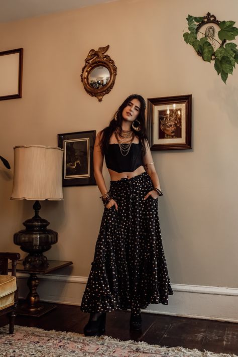 This dark bohemian skirt is that perfect mix of majestic and sweet. Crafted from a lightweight black chiffon with metallic gold detail, it features pockets, soft lining, and a drawstring waist for comfort and versatility. Whether you wear it high or low, or day or night, this gorgeous piece is sure to turn heads. Machine wash cold, gentle cycle, and line dry. Maxi Skirt Boho Outfit, 70s Dark Aesthetic, Dark Spring Outfits, Black Maxi Skirt Outfit Winter, Dark Boho Outfits, Bohemian Skirt Outfit, Bohemian Outfits Aesthetic, Bohemian Aesthetic Outfit, Boho Maxi Skirt Outfit