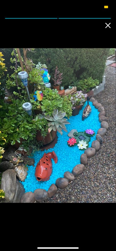 Diy fake backyard pond with glow in the dark rocks Glow In Dark Rocks For Garden, Fake Pond Diy, Glow In The Dark Garden Rocks, Landscaping With Fake Flowers, Glow Rocks Ideas, Glow In The Dark Landscape Ideas, What To Do With Big Rocks In Yard, Ocean Garden Ideas, Glow In The Dark Rocks Garden