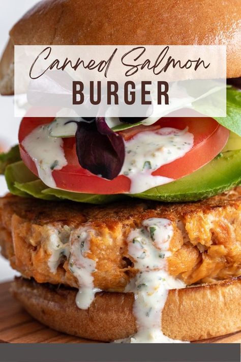 Salmon burger on a wooden board. Canned Salmon Burger Recipe, Teriyaki Salmon Burger, Salmon Patties Burgers, Salmon Burger Recipe Canned, Salmon Burger Meal Ideas, Salmon Burgers With Canned Salmon, Canned Salmon Burgers, Salmon Burger Toppings, Nutritional Psychiatry