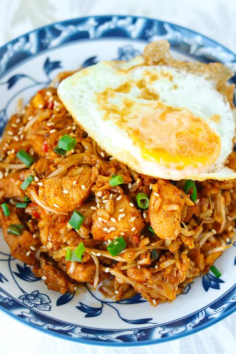 Kimchi Fried Rice with Chicken is easy to make in one wok and full of BIG and BOLD flavors! This Korean fried rice is made with savory tender chicken pieces, tangy kimchi, fragrant aromatics, veggies and the most delicious gochujang infused spicy, smoky, and tangy sauce with a hint of sweetness. Ready in 30 minutes, it’s the perfect tasty meal for busy weeknights! #kimchi #kimchifriedrice #highproteinmeals #koreanfood #korean #healthy #dinner #mealprep #maindish #friedrice | That Spicy Chick Chicken Kimchi Fried Rice, Korean Fried Rice, Asian Dinner, Rice With Chicken, Asian Dinners, Kimchi Fried Rice, Chicken Pieces, Chicken Fried Rice, Tender Chicken