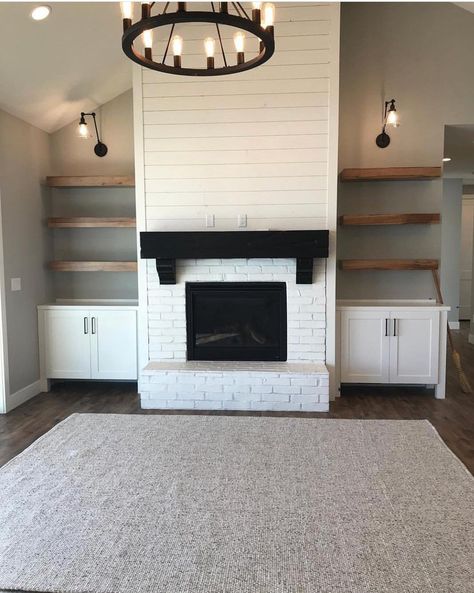 Love the white brick. We want a mantle with a brown reclaimed wood to coordinate with floor color. Built ins on side possibly a barn door to close in t.v. If possible. Shiplap painted white going up to ceiling. We do like the idea of using the color from island in kitchen on the sides of fireplace to connect both rooms. Accent wall if you must. Fireplace And Shelves, Fireplace Built Ins, Farmhouse Fireplace, Store Books, Fireplace Remodel, Seat Storage, Storage Places, Perfect House, Home Fireplace