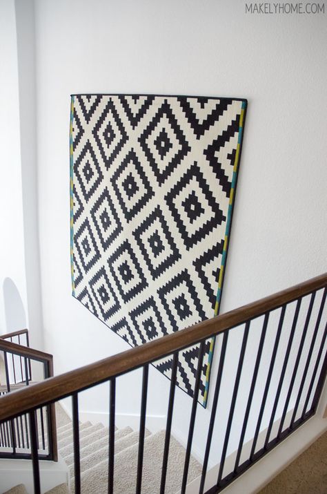 how to hang a rug on a wall via MakelyHome.com Rug On Wall Hanging, How To Decorate A Two Story Wall, Hanging A Rug On The Wall, Framed Rug Wall Art, 2 Story Wall Decor, How To Hang A Rug On The Wall, How To Hang Tapestry On Wall, 2 Story Entryway Ideas, Hanging Rug On Wall