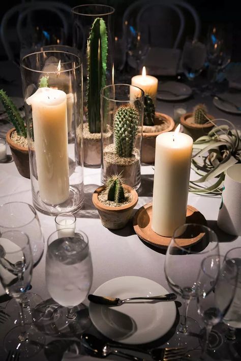 Going modern? Or even boho? Incorporate cacti! Source small cacti in pots and place them on your tables paired with a variety of candles for a whimsical look. Desert Wedding Aesthetic, Wedding Organisation, Cactus Centerpiece, Desert Party, Cactus Arrangement, Desert Theme, Hacienda Wedding, Wedding Desert, Cactus Western