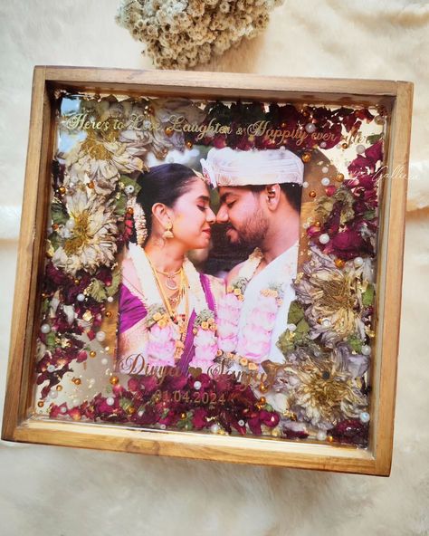 Sealing memories forever ♾️ 💕 My client Abhishek wanted to gift his friends our trending frames and placed order for 2 frames as a post-marriage gift 🎁 Upon receiving a beautiful fresh Lotus mala,we could able to dry them properly with utmost care & attention. To compliment the lotuses, added few bright rose petals & different sizes of pearls which enchanced the piece. And that's how the frame turned into 💕 I personally love how beautifully the floral shades got blended with the couple... Marriage Gifts For Couple In India, Resin Gift Ideas, Varmala Preservation, Marriage Gift, Marriage Gifts, Garland Wedding, Forever Me, Rose Petals, Resin Crafts