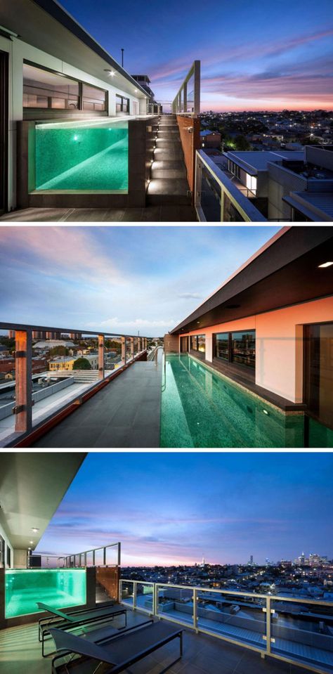 The balcony of this modern penthouse has a long see-through pool. A set of grey tiled stairs brings you to the top of the pool, while two black sun chairs lookout at the city. Balcony Swimming Pool Apartments, Pool In Apartment Balcony, Pool On Balcony, Balcony With Pool, Penthouse Pool, Balcony Swimming Pool, Tiled Stairs, Pool Apartment, Modern Penthouse Apartment