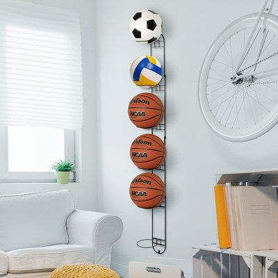 The perfect addition to any gym, garage, or shed this wall mounted black metal sports ball storage racks keeping your space neat, tidy and stylish. Simply mount to most wall surfaces with proper mounting hardware to easily store and conveniently access your basketballs, soccer balls, volleyballs, footballs, or sports and medicine balls or even kettle bells. With six metal rings you will double your storage, and create more floor space while keeping your sports and exercise balls from rolling aro Bedroom Sport, Sports Ball Storage, Soccer Bedroom, Soccer Room, Gym Storage, Gym Garage, Basketball Room, Sport Rack, Wire Shelves