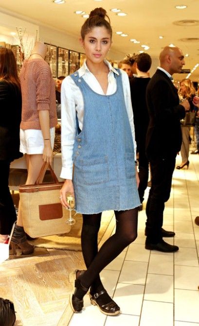 Quentin Jones teams a denim pinafore with a white shirt for an effortless but stylish look. Denim Pinafore Dress Outfit, Pinafore Dress Outfit, Denim Pinafore Dress, Denim Pinafore, Frock Fashion, African Print Dress Designs, Dungaree Dress, Pinafore Dress, Dress Outfit