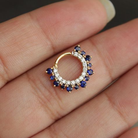 This stunning natural Diamond and natural blue Sapphire clicker style earring is a perfect accessory for your septum and daith. Crafted in 14k solid gold and a secure click mechanism, this ring fits like a charm. * Gold - 14k, Solid gold * Inner Diameter : 6 mm, 7 mm, 8 mm, 9 mm, 10mm * Gauge : 18g, 16g, 14g * Gemstone 1 : Natural White diamond * Color/Clarity : H-I, Vs-Si * Gemstone 2 : Natural Blue Sapphire (for other gemstones, please message) * Type : Clicker Find us on Instagram for exquisi Cute Septum Rings, Daith Earring, Daith Rings, Daith Jewelry, Daith Piercing Jewelry, Gold Hoop Earring, Septum Rings, Diamond Ear Cuff, Daith Earrings