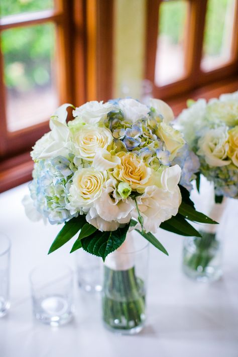 Pale yellow roses, light blue hydrangeas, white lisianthus bouquet Light Blue And Pastel Yellow Wedding, Blue Yellow White Centerpieces, Light Yellow And Light Blue Wedding, Bridal Bouquet With Hydrangeas, Pastel Yellow And Blue Wedding, White Lisianthus Bouquet, Light Blue And Yellow Wedding, Axo Philanthropy, Pale Yellow Weddings