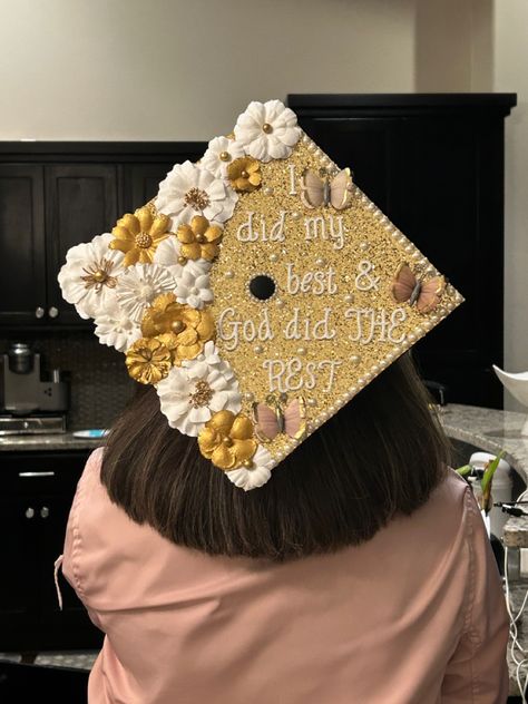 White and gold flowers and butterflies on a graduation cap. Caption on cap is “I did my best and God did the rest.” All of the supplies were bought at Hobby Lobby. I Did My Best And God Did The Rest Cap, Yellow Grad Cap Ideas, God Did Graduation Cap, White And Gold Grad Cap, Graduation Cap Designs Yellow, Graduation Cap Designs Gold, Yellow Cap And Gown, Graduation Cap God, God Graduation Cap Ideas