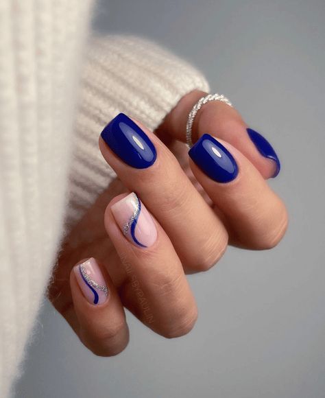 Find inspiration for 55 beautiful blue winter nail designs from solid to ombre to glitter styles perfect for the cold season. Get ideas for French tips with blue, royal, and navy polish, snowflake nail art, and swirling or marbled looks that capture the icy essence of winter. #winter #winterstyle #wintermanicure #bluenails #winternails #lightbluenails $royalbluenails #darkbluenails #navybluenails Navy And Silver Nails, Blue Winter Nails, Royal Blue Nails Designs, Blue And Silver Nails, Silver Nail Designs, Royal Blue Nails, Dark Blue Nails, Navy Nails, Unghie Sfumate