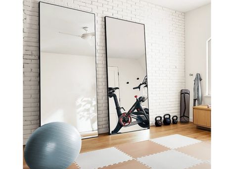 Use large mirrors to create a makeshift home gym, and see other creative ways to use full-length mirrors in your home decor. | 10 Ways to Decorate With Floor Mirrors That Are Right on Trend Home Gym Mirror Ideas, Gym Basement, Home Gym Mirrors, Gym Mirror, Gym Bar, Workout Room Home, Floor Length Mirror, Gym Mirrors, Full Length Floor Mirror