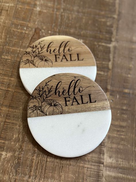 Coasters are a necessity for every home. Yours should reflect your style. Our wood and white coasters can be engraved to do just that: our sunflower coasters add a fall flair to any tabletop. Marble and wood Please note: Marble is a natural product. Variations in color, and texture, plus noticeable cracks and flaws are to be expected as that is the nature of the product Each coaster may be different in marbling and wood color. Measures 4" x 4" Wipe clean Includes foam bottom pads to protect furniture Imported Riser sold separately Style Coasters Finish Hello Fall Sunflower Dimensions 4 x 4 Design Marble and wood Please read our FAQ page prior to purchasing. Install the included handles and use a barrier between our tiered tray and food. Engraved Coaster Ideas, Wood And Epoxy Coasters, Wood Burned Coasters Diy, Coaster Engraving Ideas, Hand Painted Coaster Ideas, Wood Coaster Art, Wood Coaster Ideas, Wood Burn Coasters, Wood Burning Coasters