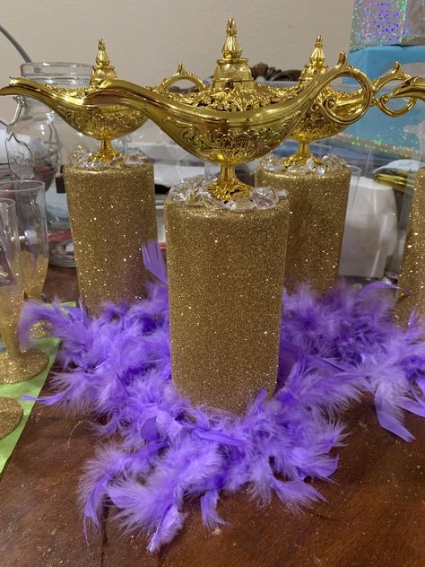 Do it yourself Aladdin glitter gold jasmine feather lamp centerpiece genie Jasmine Birthday Table Decorations, Arabian Nights Table Decorations, Genie Theme Party, Genie Lamp Centerpiece Ideas, Jazmine Quinceanera Theme, Princess Jasmine Centerpieces, Aladdin Wedding Centerpieces, Alladin Themed Wedding, Arabian Nights Sweet 16 Party