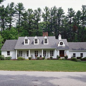 Adding dormers helped give this ranch a new look outside and extra room inside. Their classic gable fronts repeat the roof pitch of the original structure. New windows, siding, and porch columns complement the dormers' classic simplicity. Dormers Added To Ranch, Gabled Windows, Greek Pillars, Tri Level House, Ranch Home Remodel, 80s Country, Ranch Renovation, Home Renovation Costs, Roof Pitch