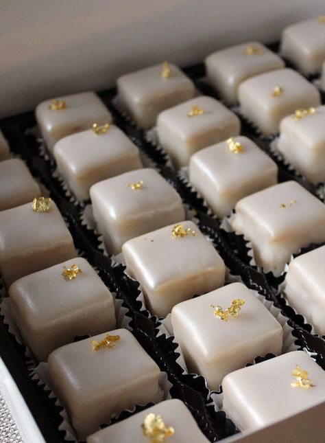 Petit Four Demitasse with gold flakes Round Petit Fours, Engagement Party Petit Fours, Wedding Petite Fours, White And Gold Petit Fours, White Petit Fours, Wedding Petit Fours, Gold Desserts, Petit Fours Wedding, Wedding Cake Gold Leaf