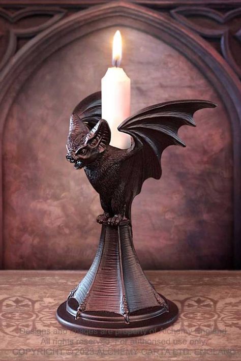 This beautifully sculpted Bat candle stick is hand finished in the finest quality black resin. A dark and dramatic candle stick to bestow your dining table, boudoir or altar. Silent sentinel delighting in night. Flying on the border between one world and the next. Be it bird or beast at dusk or dawn, forever unseen at the dark of the moon. Candle stick not included, but you can purchase candles separately. Weight & Dimensions (approx.):H: 18.2cm (7.17") W: 11.8cm (4.65") D: 11.5cm (4.53") Weight Halloween Candlesticks, Gothic Candle Holder, Night Flying, Gothic Candles, Alchemy Gothic, Halloween Room Decor, Resin Sculpture, Halloween Candles, Halloween Vintage