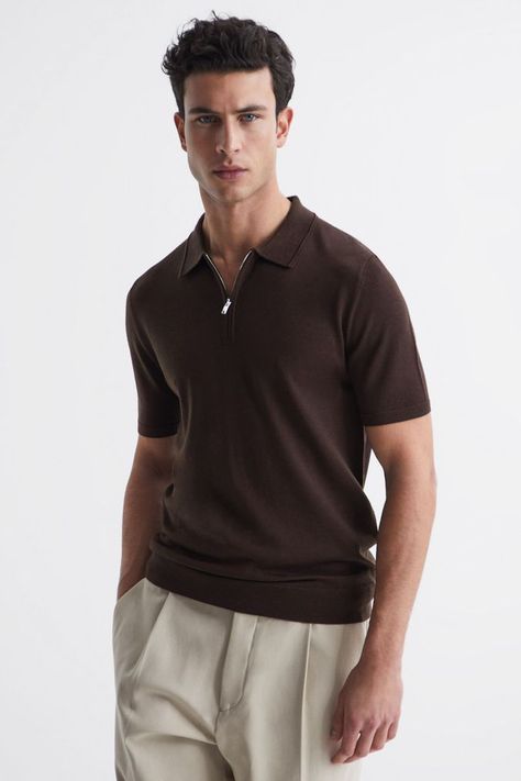 The Maxwell short-sleeved polo is a knitted style crafted from wool yarns and finished with a zip-neck detail, nodding to the preppy styles of the Fifties. Style it with a pair of chino trousers, and sneakers and finish with a bomber jacket for a relaxed retro vibe.  Zip-neck detail. Short sleeves. Ribbed trims. Hand wash only. 100% Wool. Polo Outfit Men, Fifties Style, Polo Outfit, Classy Outfits Men, Bitter Chocolate, The Fifties, Zip Polo, Black Polo Shirt, Chino Trousers