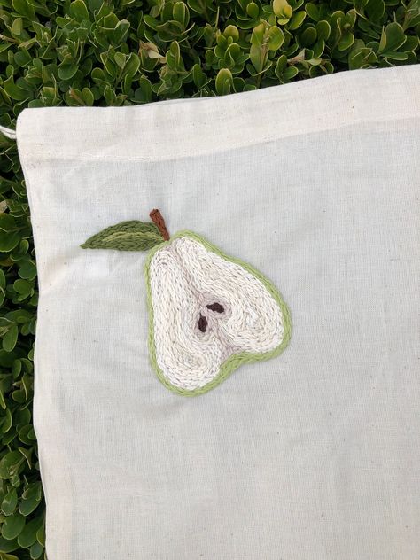 "Hand embroidered reusable produce bag featuring a green pear. Material is cotton muslin and features a drawstring closure. Say goodbye to unsustainable plastic produce bags and say hello to beautifully crafted sustainable fabric produce bags! The bag is 10\" x 12\". PLEASE NOTE: this item is made to order. It can take anywhere from 2-10 days for me to make and ship your order depending on my current workload. Send me a message for a more precise time estimate!" Fruit Embroidery Patterns, Pear Embroidery, Vegetable Embroidery, Embroidery Aesthetic, Embroidered Fruit, Fruit Embroidery, Embroider Ideas, Clothes Embroidery Diy, Decorative Embroidery