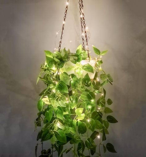 PRICES MAY VARY. Hanging Planter With Lights : Illuminate your space with LED string lights that cast a captivating glow on the hanging planter, transforming your room with a visually stunning display. The appearance and structural design of the hanging plant holder for indoor outdoor plants are conducive to plant growth, meet all your gardening needs, and are suitable for matching various hanging plants. Such as ivy, herbs, ferns, philodendrons, succulents, flowers or other plants. Indoor/Outdo Hanging Plant Indoor Decor, Ways To Hang Plants From Ceiling, Hanging Lights And Plants, Bohemian Bedroom Plants, Led Lights Bathroom Ideas, Fake Plants Decor Living Rooms, Fairy Bathroom Ideas, Hanging Plants For Bedroom, Plants With Lights